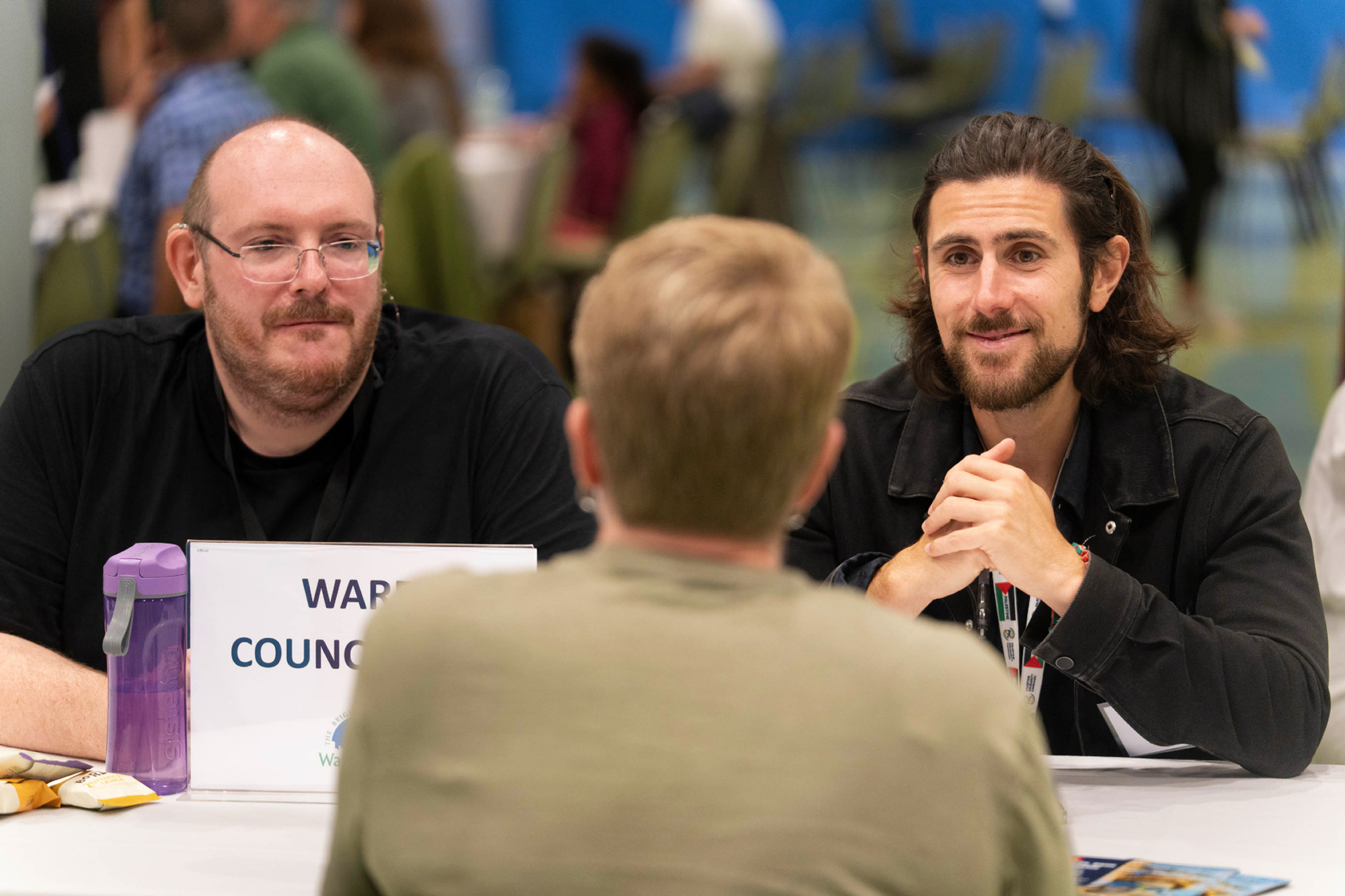 Councillor Matthew Tiller and Councillor Aydin Dikerdem are pictured listening to a resident