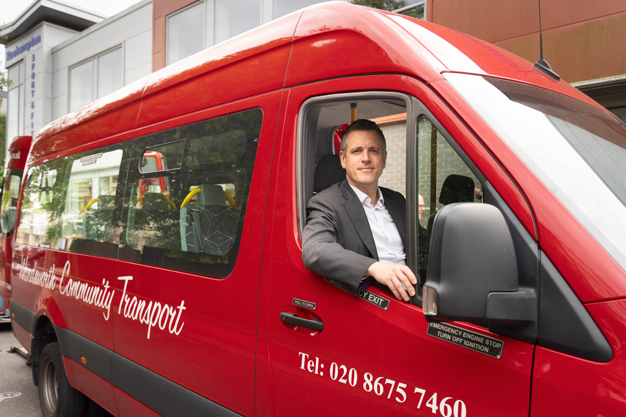 Wandsworth Council Leader Simon Hogg in the driving seat of the Wandsworth community bus