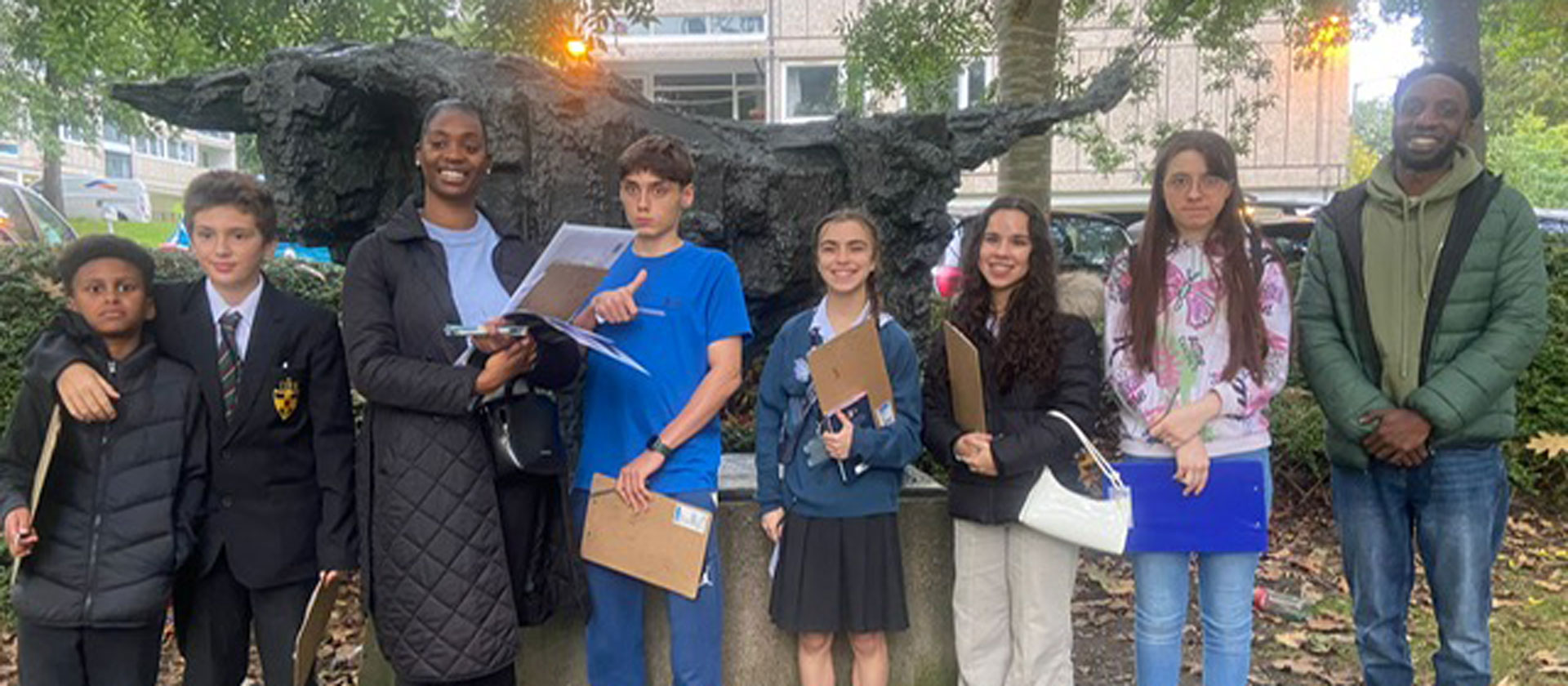 Members of the Youth Advisory Panel are pictured standing in front of the Bull statue on Downshire Field